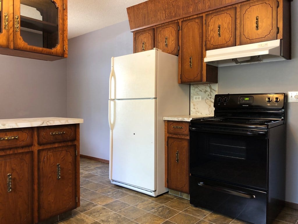 The fridge has been replaced, it is now a new black one.