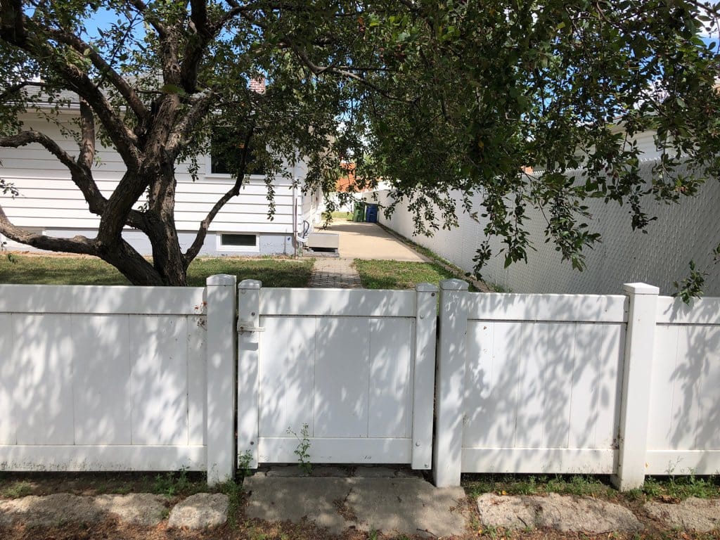 Looking into the back yard, concrete patio behind house.