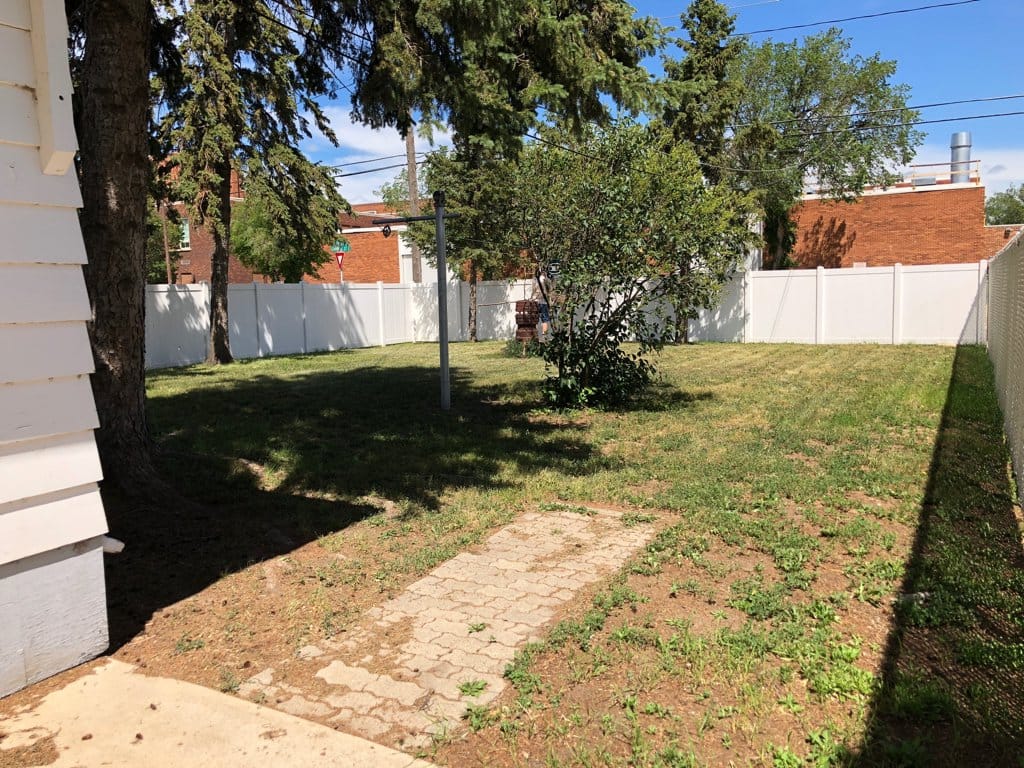 North (Caribou St) side yard.  Grass will look better, the new tenants have been nursing it.  This is a 6 foot fence.